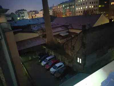 a group of cars parked in a parking lot at night at Kapetan Misina-Nina in Belgrade
