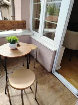 a table and two chairs in front of a window at Kapetan Misina-Nina in Belgrade