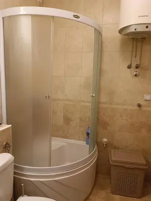 a bathroom with a shower and a toilet at WHITE apartment in Belgrade