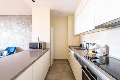 a kitchen with white cabinets and a counter top at BW Residences penthouse 2BDR with pool&gym in Belgrade