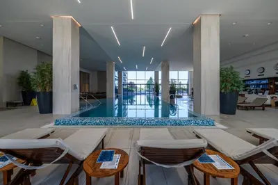 a lobby with tables and chairs in a building at BW Residences penthouse 2BDR with pool&gym in Belgrade
