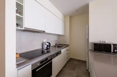 a kitchen with a sink and a microwave at BW Residences penthouse 2BDR with pool&gym in Belgrade