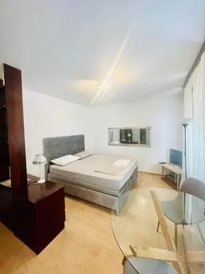 a bedroom with a bed and a table and a chair at Dorcol hideaway in Belgrade