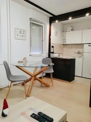 a kitchen with a table and chairs in a room at Dorcol hideaway in Belgrade