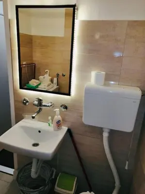 a bathroom with a sink and a mirror at Dorcol hideaway in Belgrade