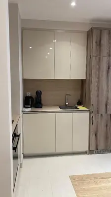 a kitchen with white cabinets and a sink at DOM Boutique Apartments AURORA in Belgrade
