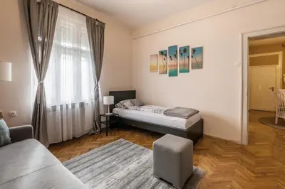 a living room with a bed and a window at Neimar Apartment with Great Wi-Fi and free parking in Belgrade