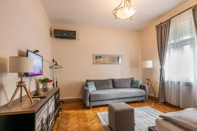 a living room with a couch and a tv at Neimar Apartment with Great Wi-Fi and free parking in Belgrade