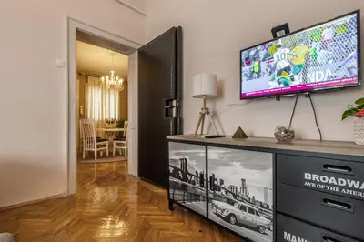a living room with a flat screen tv on a wall at Neimar Apartment with Great Wi-Fi and free parking in Belgrade