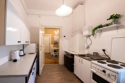 a kitchen with white cabinets and a stove top oven at Neimar Apartment with Great Wi-Fi and free parking in Belgrade