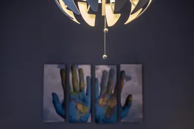 a painting of a hand hanging from a chandelier at Neimar Apartment with Great Wi-Fi and free parking in Belgrade