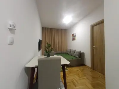 a living room with a table and a couch at Apartman Ledine in Ledine