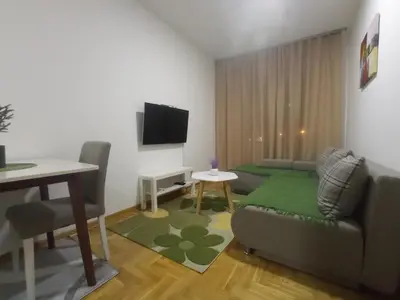 a living room with a couch and a table at Apartman Ledine in Ledine