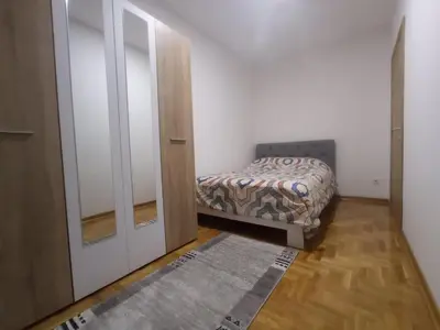 a small bedroom with a bed and a closet at Apartman Ledine in Ledine