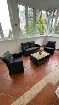 a living room with couches and a table and windows at Filip Luxury Suite in Belgrade