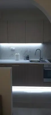 a white kitchen with a sink and a light at Filip Luxury Suite in Belgrade