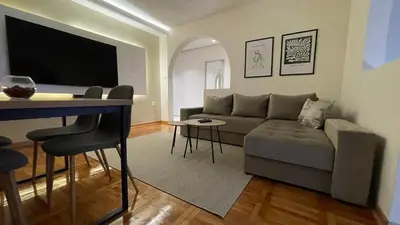 a living room with a couch and a table at Filip Luxury Suite in Belgrade