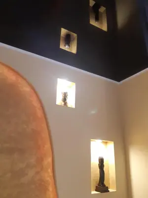 a room with three pictures on the wall and a sculpture at Brdo lux in Belgrade