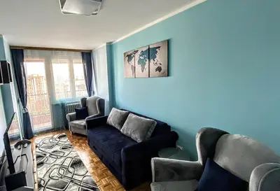 a living room with a couch and two chairs at Peti in Belgrade