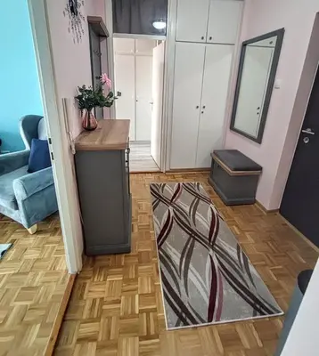 a living room with a rug on the floor at Peti in Belgrade