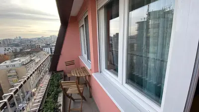 a balcony with two chairs and a window at Peti in Belgrade