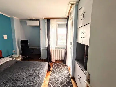 a small bedroom with a bed and a window at Peti in Belgrade