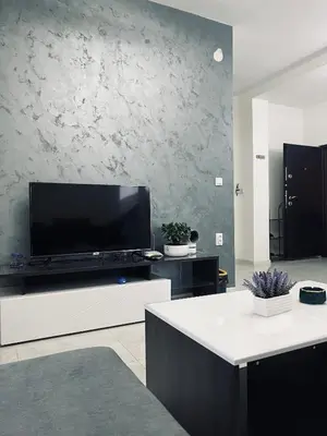 a living room with a large flat screen tv on a wall at \u99a8\u4e4b\u5bb6-\u534e\u4eba\u516c\u5bd3\u6c11\u5bbf \u4e09\u5ba4\u4e00\u5385 in Ledine