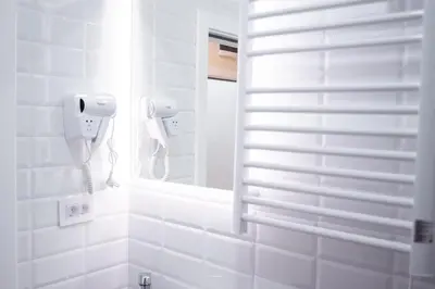 a bathroom with a mirror and a phone on the wall at Premium Suites Terazije in Belgrade