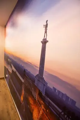 a painting of a statue on top of a lighthouse at Premium Suites Terazije in Belgrade
