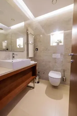 a bathroom with a white sink and a toilet at Hotel Tamiš & Spa in Pančevo