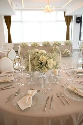 a table with silverware and flowers on it at Hotel Tamiš & Spa in Pančevo