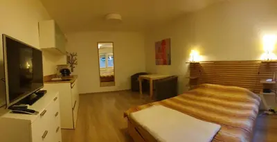 a hotel room with a bed and a television at STUDIO 77 in Belgrade