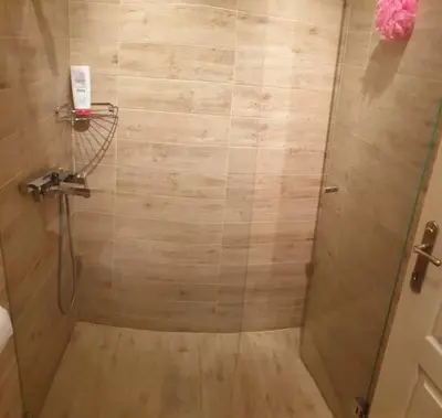 a shower with a glass door in a bathroom at STUDIO 77 in Belgrade