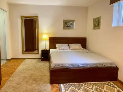 a bedroom with a bed and a mirror at Dorcoleta Apartment in Belgrade