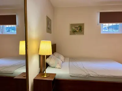 a bedroom with two beds and a mirror at Dorcoleta Apartment in Belgrade