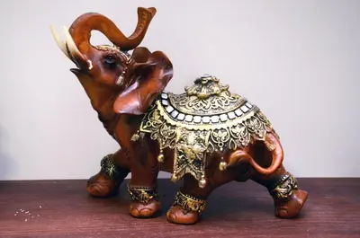 a wooden figurine of an elephant sitting on a table at Dorcoleta Apartment in Belgrade