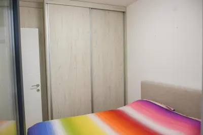 a bedroom with a rainbow bed and a closet at Apartment Barcelona Zemun Belgrade in Zemun
