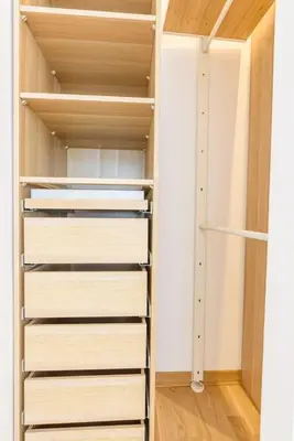 a walk in closet with white shelves at Brand new flat near Tesla museum in Belgrade
