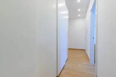 an empty hallway with white walls and wooden floors at Brand new flat near Tesla museum in Belgrade