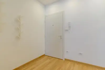 an empty room with white walls and a door at Brand new flat near Tesla museum in Belgrade