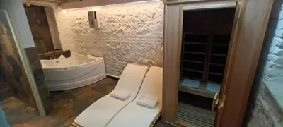 a bathroom with a sink and a toilet and a tub at Old Café Spa Apartment - Unique space in Belgrade