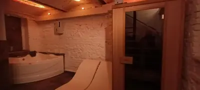 a bathroom with a tub and a sink and a toilet at Old Café Spa Apartment - Unique space in Belgrade