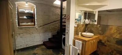 a bathroom with a sink and a staircase in it at Old Café Spa Apartment - Unique space in Belgrade