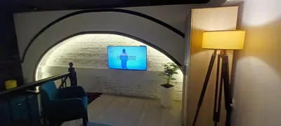 a hallway with an archway with a tv and a lamp at Old Café Spa Apartment - Unique space in Belgrade