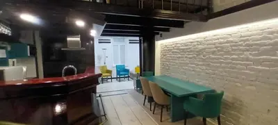 a dining room with a green table and chairs at Old Café Spa Apartment - Unique space in Belgrade