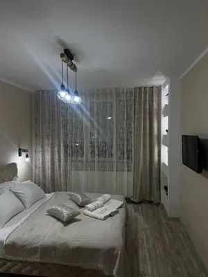 a bedroom with a bed with two towels on it at Apartman Trg Lux in Arandjelovac