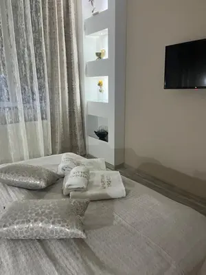 a bedroom with a bed with two pillows on it at Apartman Trg Lux in Arandjelovac
