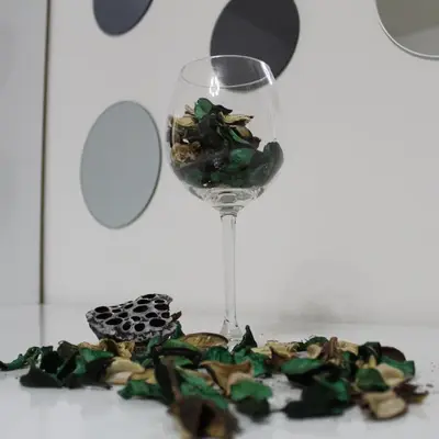a glass of wine sitting next to a pile of debris at N&AA apartman in Belgrade