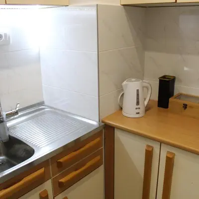 a small kitchen with a sink and a counter top at N&AA apartman in Belgrade