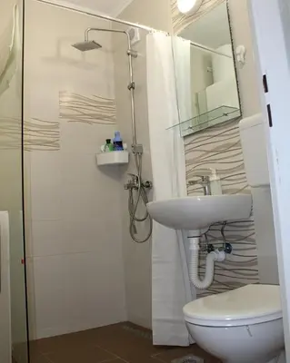 a bathroom with a sink and a toilet and a mirror at N&AA apartman in Belgrade